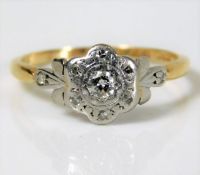 An antique 18ct gold daisy style ring set with 0.1