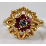 An 18ct rose gold ring set with red & blue paste stones 5.2g size R