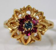 An 18ct rose gold ring set with red & blue paste stones 5.2g size R