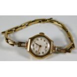 A 9ct gold cased watch with gold plated strap 14.8