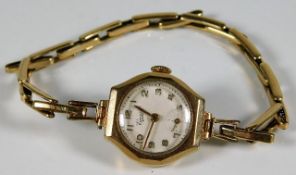 A 9ct gold cased watch with gold plated strap 14.8