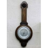 An oak cased barometer lacking thermometer