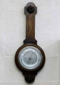 An oak cased barometer lacking thermometer