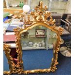 A decorative ornate gilt framed mirror 56in high x