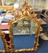 A decorative ornate gilt framed mirror 56in high x