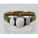 A 9ct gold ring set with three opals, one with chi