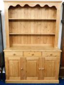 A farmhouse style pine dresser with three drawers