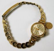 A ladies gold wristwatch & strap, strap tests as 1