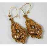 A pair of yellow metal earrings of decorative embo