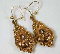 A pair of yellow metal earrings of decorative embo