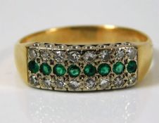 A yellow metal ring, tests as 18ct gold with approx. 0.16ct diamond & emerald ring 5g