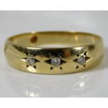 A 9ct gold gipsy style ring set with three diamond