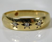 A 9ct gold gipsy style ring set with three diamond