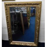 A decorative gilt framed mirror 42.5in high x 30.2