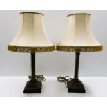 A pair of brass corinthian style lamp bases with s