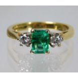 An 18ct gold ring set with approx. 0.5ct of diamond & emerald 3.7g size J