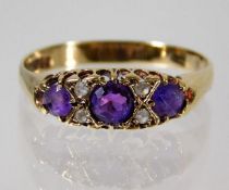 A 9ct gold ring set with amethyst (chip to side stone) & white stones 2.1g size T/U