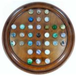 An antique solitaire game with marbles, small repa