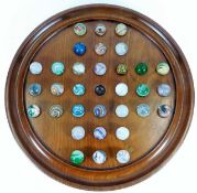 An antique solitaire game with marbles, small repa