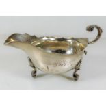 A silver sauce boat, inscribed 175g