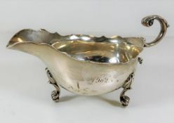 A silver sauce boat, inscribed 175g