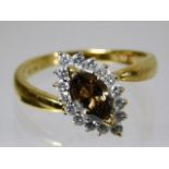 An 18ct gold ring with cinnamon centre diamond of