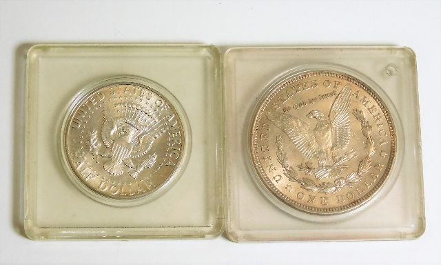 A 1921 silver US dollar twinned with a 1964 Kenned