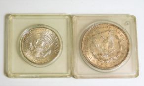 A 1921 silver US dollar twinned with a 1964 Kenned