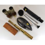 A small brass telescope, a polished fossil stone &
