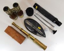 A small brass telescope, a polished fossil stone &