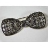 A silver bow brooch set with marcasite