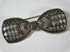 A silver bow brooch set with marcasite