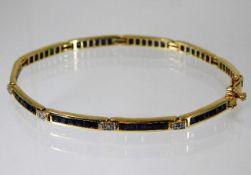 A 14ct gold bracelet set with diamond & sapphire 8