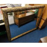 A gilt framed mirror with decorative frame 53in wi