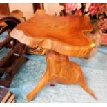 A carved wood table in naturalistic form. Provenan