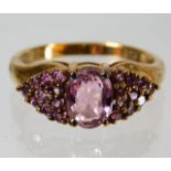 A 9ct gold ring set with pink stones, possibly top