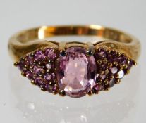 A 9ct gold ring set with pink stones, possibly top