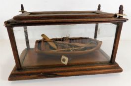 A Victorian cased with hand carved model of rowing