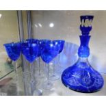 A Bohemian cut glass decanter with blue overlay gl