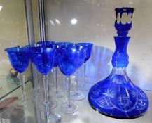 A Bohemian cut glass decanter with blue overlay gl