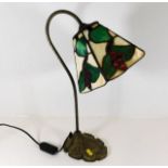 A decorative Tiffany style desk lamp with red berr