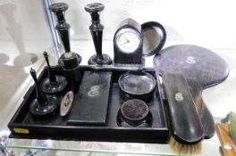 An ebonised dressing table set with silver back na