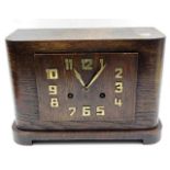 An art deco oak cased clock with brass numerals 8.