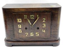 An art deco oak cased clock with brass numerals 8.