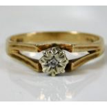 A 9ct gold ring with a small illusion set diamond