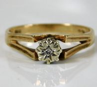 A 9ct gold ring with a small illusion set diamond