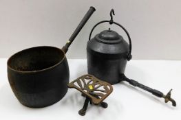 A cast iron pan twinned with a cast iron kettle &