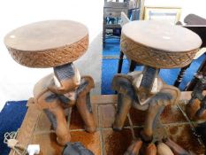 A pair of carved elephant tables 20in high