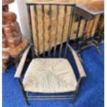 An Ernest Gimson style low level rush seated chair