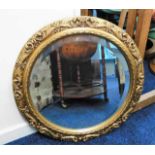 A decorative ornate circular mirror 26.75in diamet